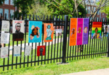 Posters hang on a fence outside Bethesda-Chevy Chase High School at the Black Lives Matter protest on East-West