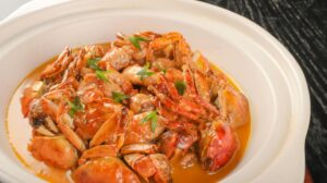 Stock photo of a plastic white plate filled with crab and seafood.