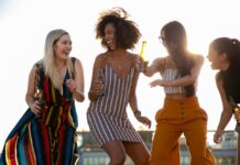 4 Live Music Opportunities to Close Out the Summer: Aug. 22-24 Stock photo of three young women dancing at a rooftop party.