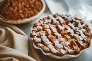 Stock photo of a latticed apple pie on a table.
