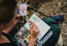 4 Artsy Events This Weekend: Oct. 17–18 Stock photo of a person painting with watercolor in the woods.