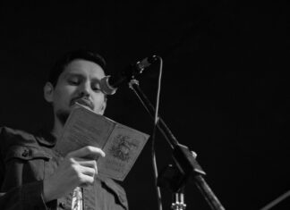 Things to Do This Weekend in Montgomery County (July 10-12) Man reading poetry from a book at an open mic