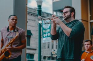 Several men playing jazz instruments outside