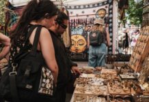 People looking at a booth at a craft fair